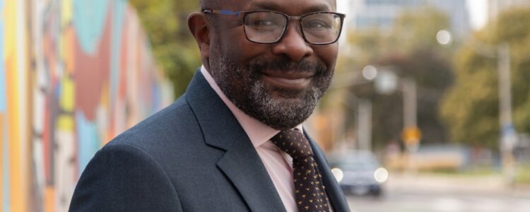 Photo of Dr. Kwame McKenzie on Gerrard Street in Toronto